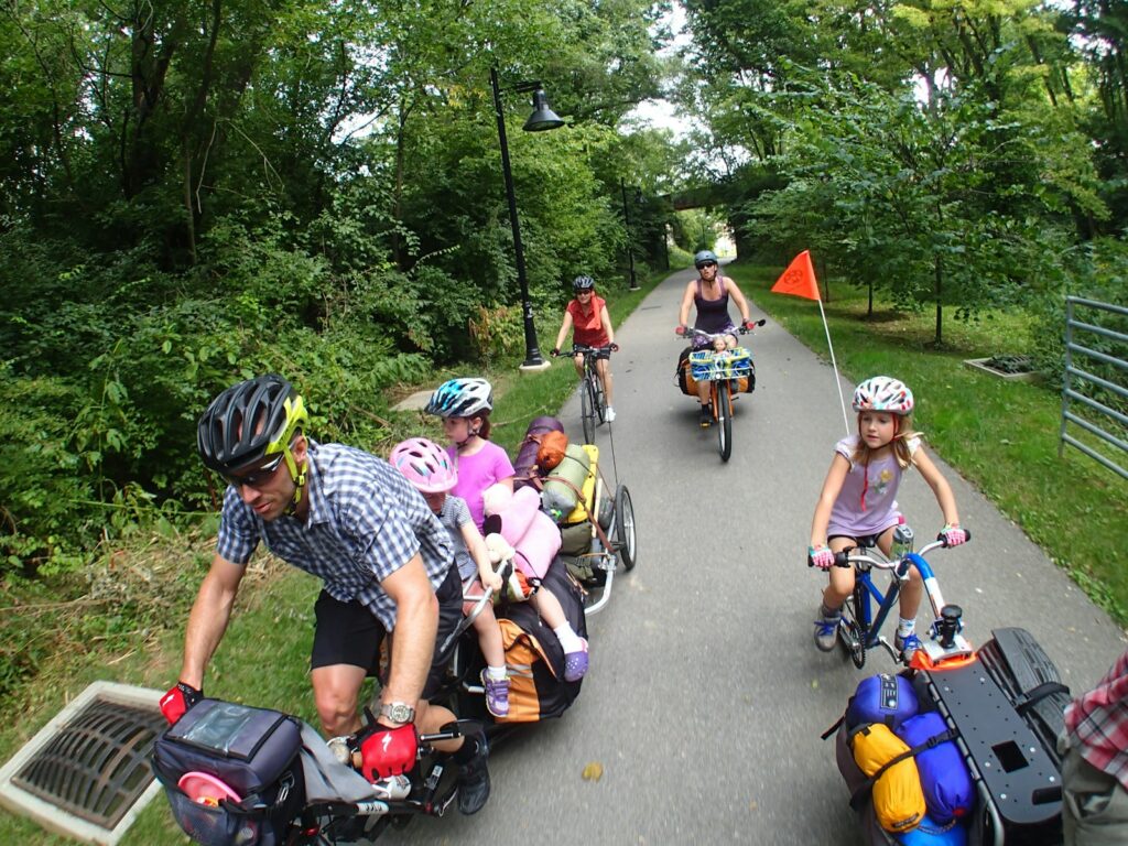 people riding bicycle on road during daytime