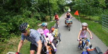 people riding bicycle on road during daytime